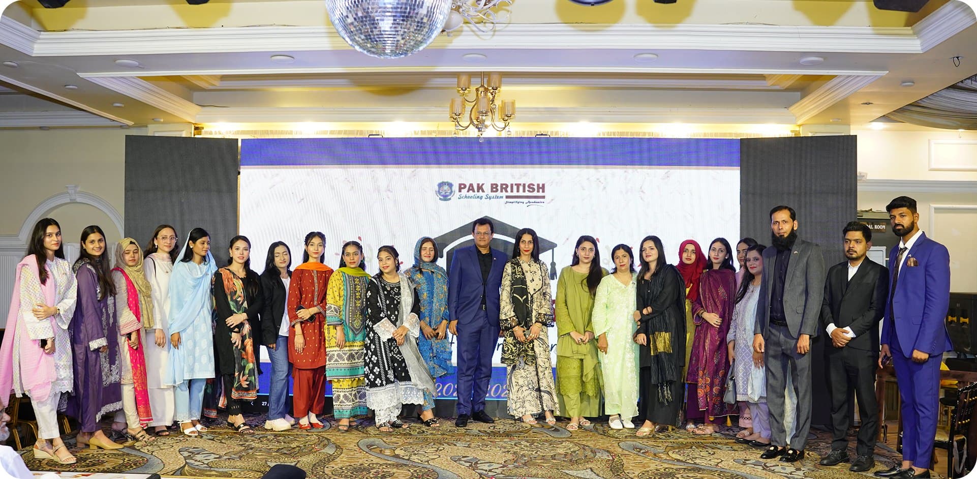 Pak British students and staff gathered on stage at a Schooling System event